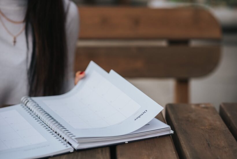 crop woman with notebook in park